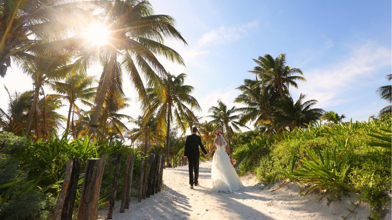 There are pros and cons to getting married abroad. It’s not just about hopping on a flight and saying ‘I do’ on a beach, but it can be worth it. As well as the time of year, monsoon season, local customs and food, there are lots of things to consider when getting married abroad. Planning is key and you may have to book the wedding around 18 months before the event to ensure everything gets planned and people know about it beforehand. You have to think about accessibility for family and friends. Direct flights that are regular and affordable with a short travel time from the airport will give them more incentive to accept the invitation. You would also need to check the details of your marriage ceremony under local law. Each country has different rules when it comes to marriage. In many places, it can be difficult to have a legal ceremony unless you are resident for a number of weeks or months. In this case, the norm would be to have a legal ceremony at home and a symbolic blessing on the day. A local wedding planner who knows the area will be invaluable. From sourcing key suppliers, liaising with vendors in the region and explaining your requirements in the local language, the help will be essential. Choose an established, English-speaking planner who has experience working on weddings in your region and of the style you want to create. This does not mean that you shouldn’t visit the venue, florist and bakery yourself. You need to ensure that it’s what you want for your big day. Popular Abroad Weddings Europe Lake Garda, Italy Italy’s largest lake stretches across three regions in the north of the country, so no wedding abroad in Lake Garda will ever be the same as each other. At its northern end, the mountainous scenery makes a stunning backdrop for your photos with historic castles as the perfect venue. In the south of Lake Garden, the lakeside has an almost Mediterranean feel and relaxed waterfront towns where you can tie the knot. Santorini, Greece Magical sunsets, breathtaking views, towering cliffs and whitewashed villages. This crescent-shaped islands in the Aegean Sea is Santorini, the little paradise on earth which will complete your vows of a lifetime of love and togetherness. Plan your dream wedding on a panoramic terrace on the edge of the Caldera, in one of the famous Santorini wineries or on one of the renowned black volcanic sand beaches. As the sun is setting, the glow of the orange and red in the cliffs will be cherished forever. Caribbean White-sand beaches, Bombay Sapphire waters and an infectious party spirit means that the islands of the Caribbean were made for weddings. Each island has something different to bring the the table. Aruba is home to some of the longest, whitest beaches going, the Dominican Republic livens up evening do’s with merengue music and rum cocktails, and Jamaica offers a reggae soundtrack and a laid-back attitude. Cuba does weddings with a Latino-style swing of the hips, combining all the traits of a Caribbean paradise with its iconic capital city, Havana. Then there is of course, St Lucia, where the two of you can stand at the altar with the mighty twin peaks of the Piton Mountains towering behind you. Latin America Whether you fancy golden sands and golden sunsets, or beaches whiter than your wedding cake, Latin America delivers. Opt for Mexico and you’ll have a choice between the east and west coasts. In the east, it’s all white sands, Tiffany-blue waters and A-list-worthy hotels. While on the west coast you can expect sunset ceremonies overlooking caramel-coloured sands, with the Sierra Madre mountains as a backdrop. Further south, Costa Rica has the same gold sands and sunset vistas, but with the added dose of adventure.